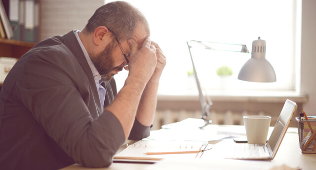 Senhor stressado com as mãos na cabeça
