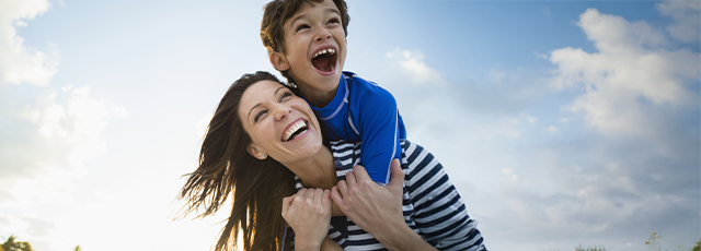 mãe e filho sorriem durante prática de exercício com moderação